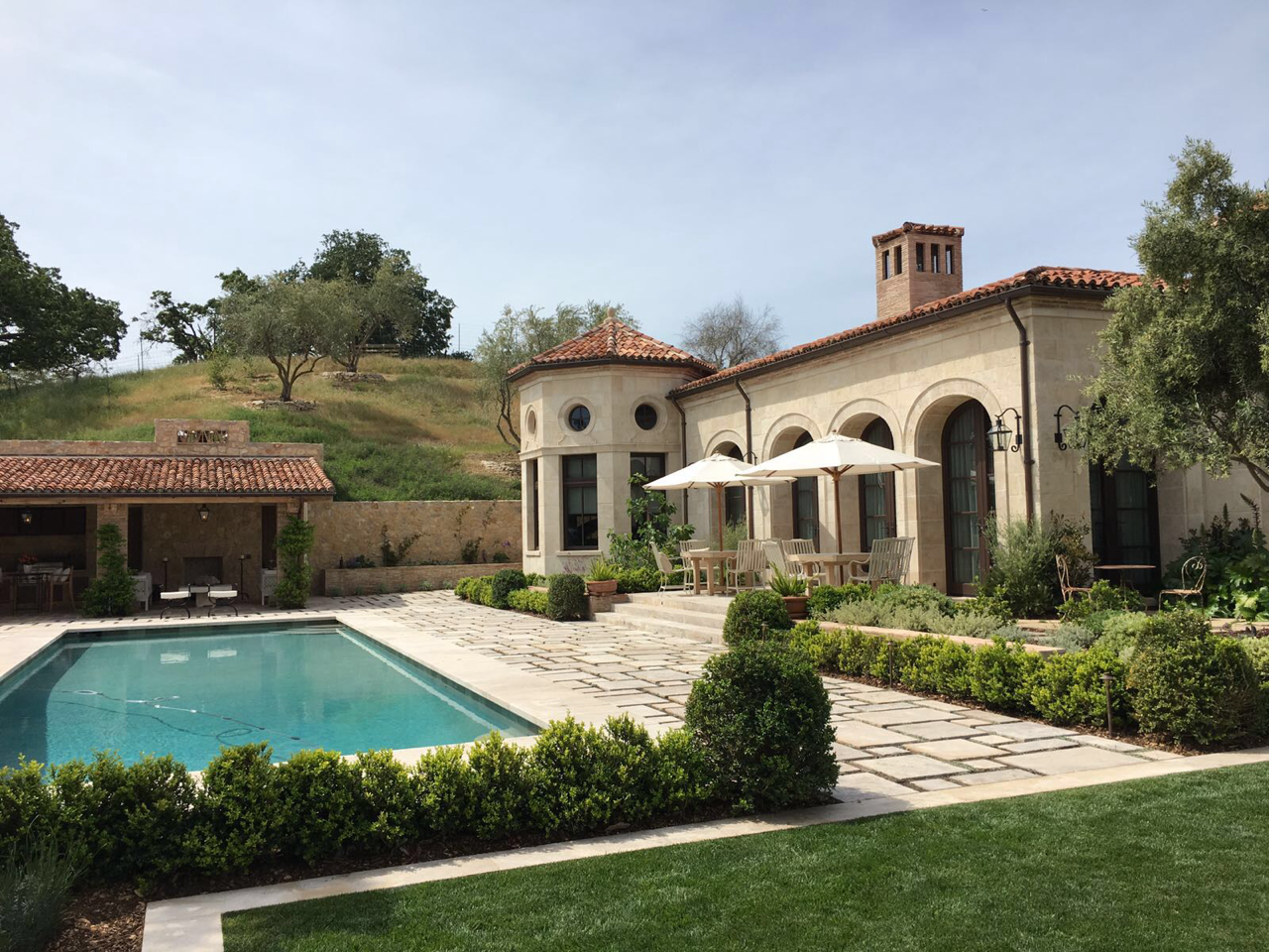 Pool terrace and stone facade with arched windows