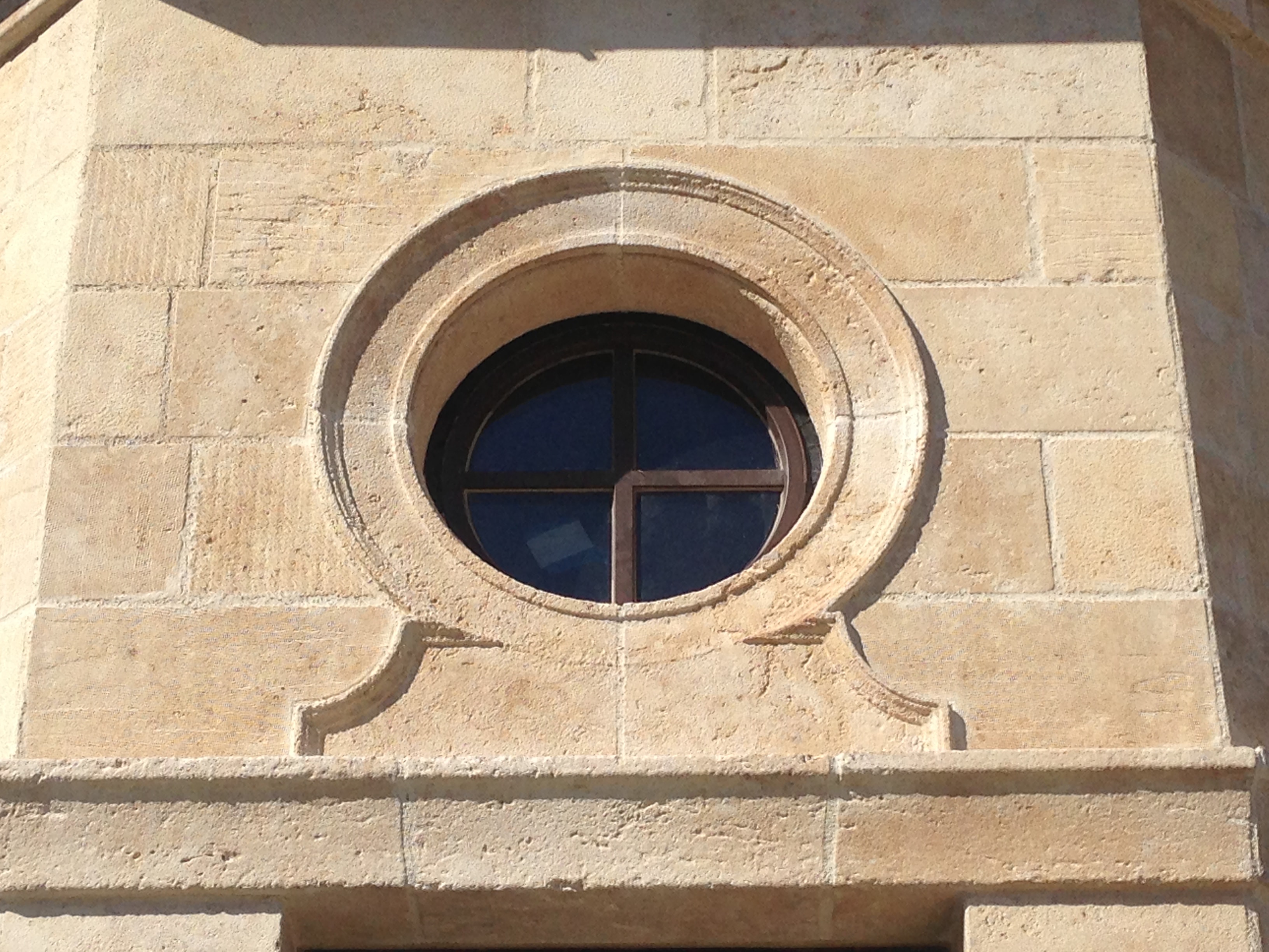 Carved circular stone window surround detail