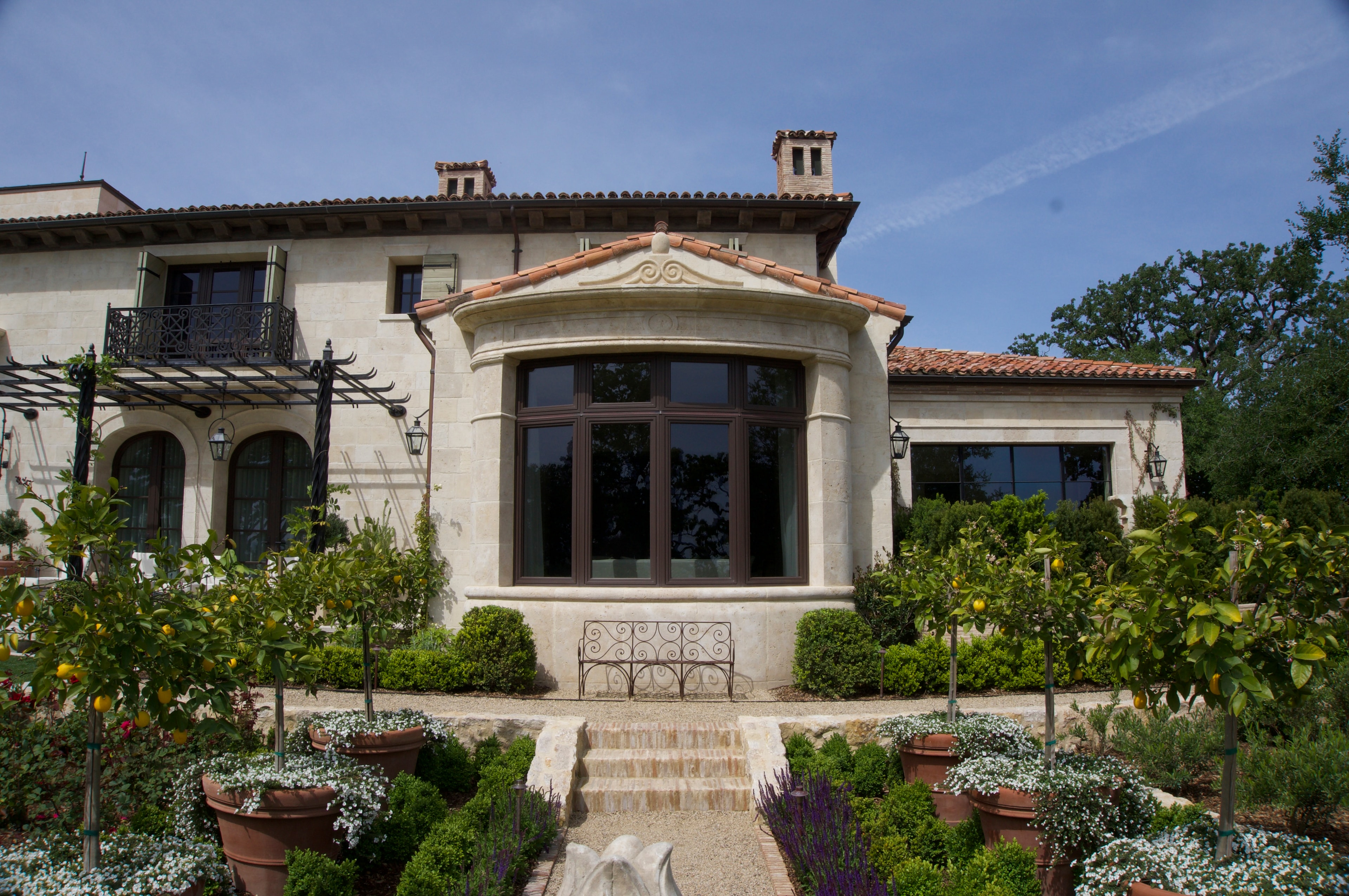 Rear facade with stone bay window surround and iron balcony